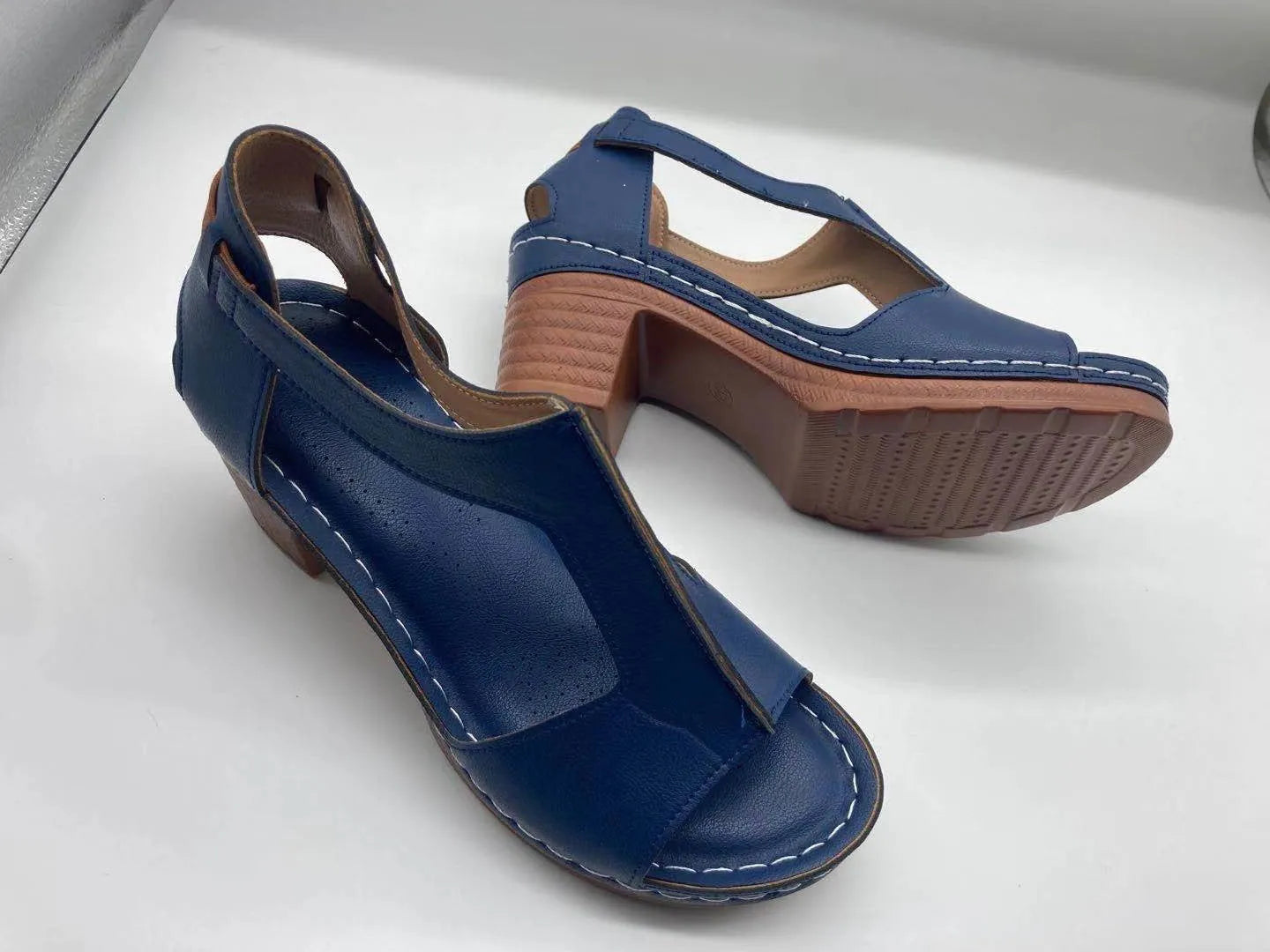Plus size beige wedge sandals with peep toe, open sides, and a Roman-style ankle buckle.