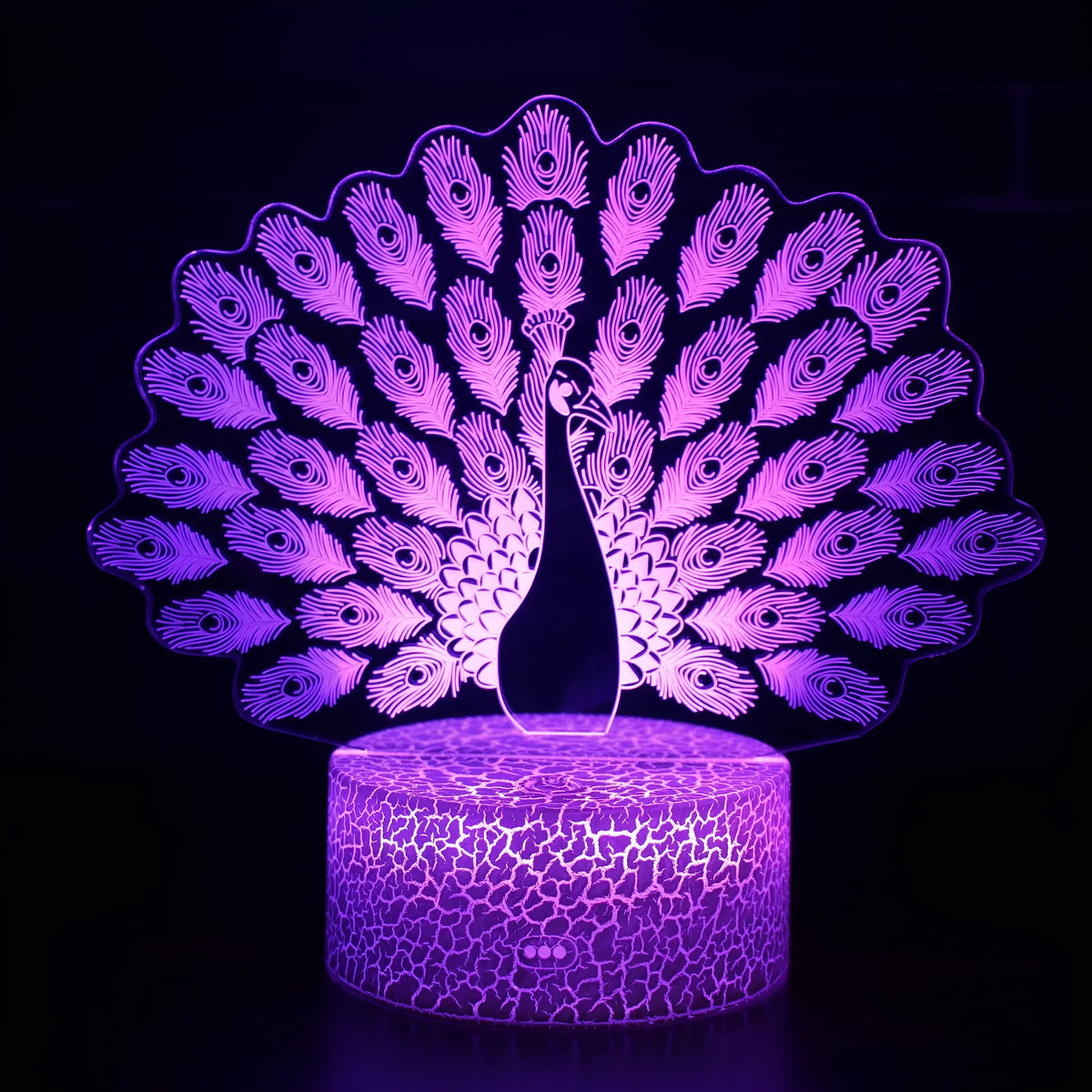 Small acrylic 3D touch-controlled USB table lamp with colourful crack-effect base on a desk.