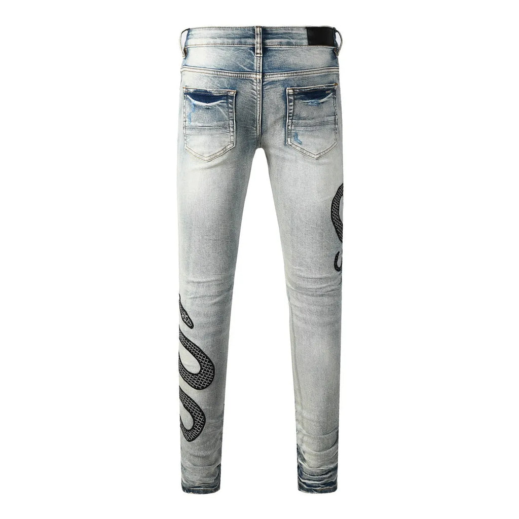 Men's blue distressed skinny jeans with wash finish showing button fly and slim fit