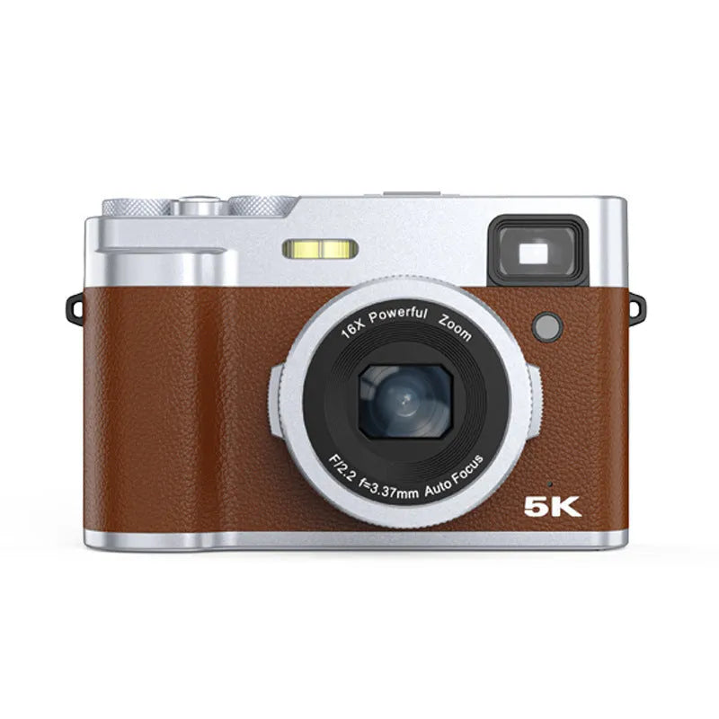 Black 5K HD digital camera with dual lenses and an optical viewfinder on a table with its accessories.