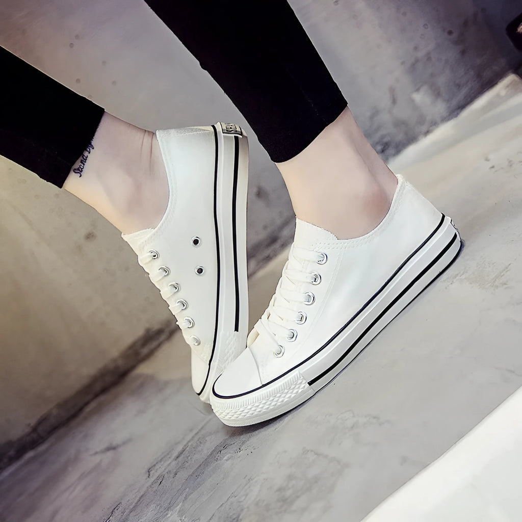Women's solid colour canvas casual shoes on a plain background, showing the simple design.