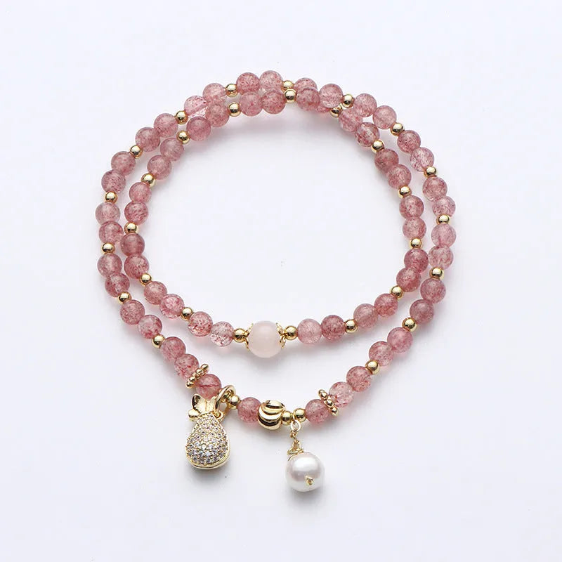 Women's geometric strawberry quartz crystal bracelet for money drawing and luck.