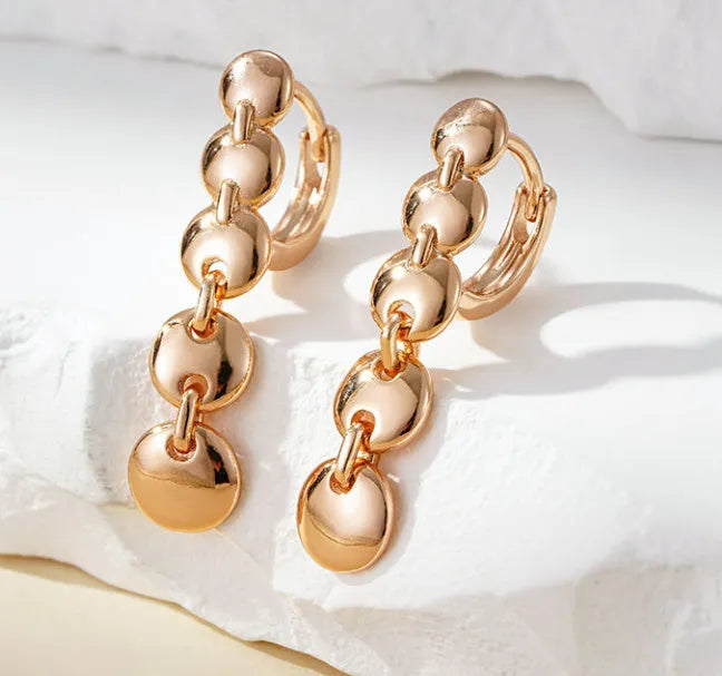 Retro gold-coloured copper circle earrings with woven texture and long dangle design