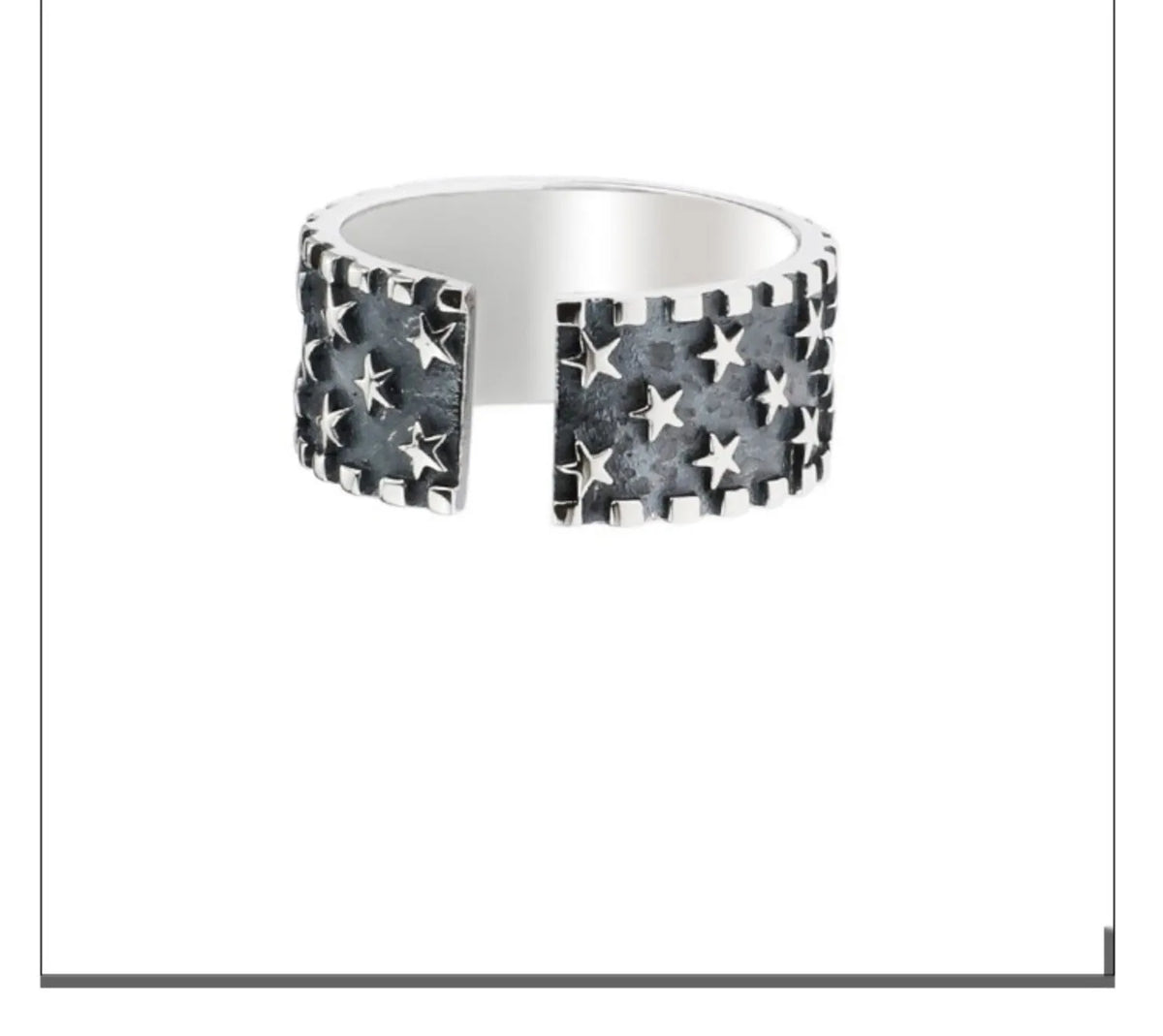 Close-up of an adjustable silver ring with a geometric multi five-pointed star design on a neutral background.