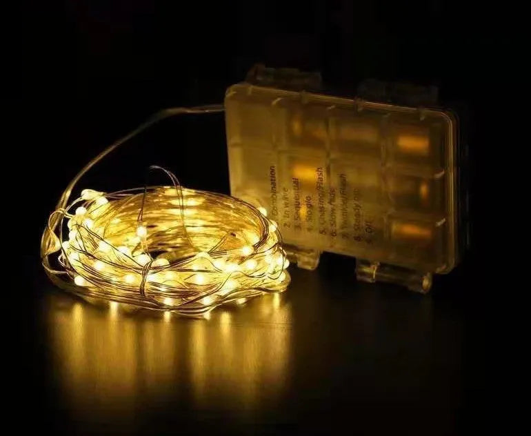 12-metre copper wire LED string lights with 120 bulbs arranged in garden setting