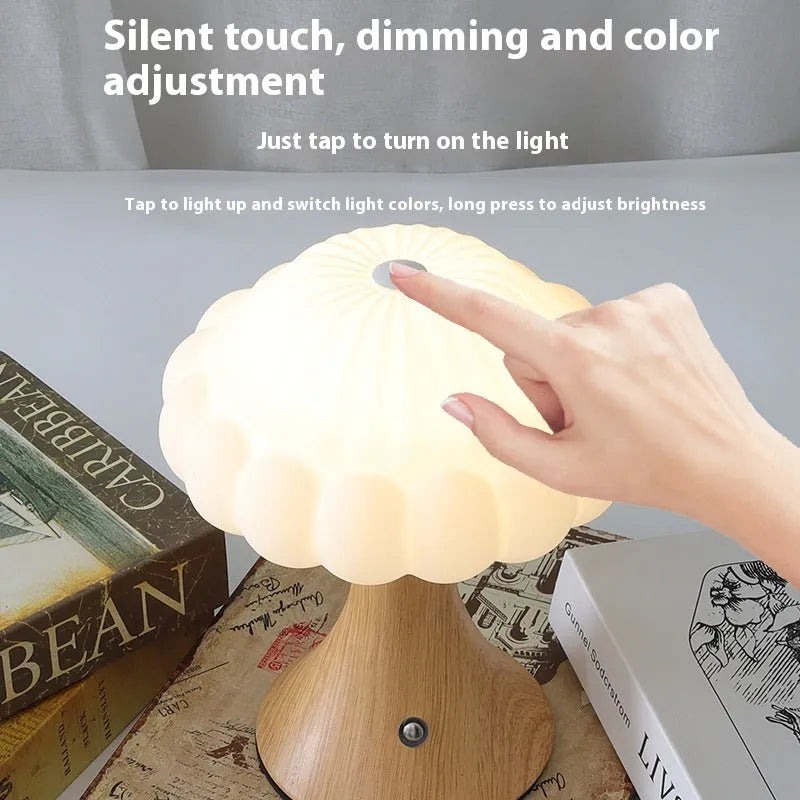 Mushroom-shaped touch control night lamp in wood grain colour on a table.