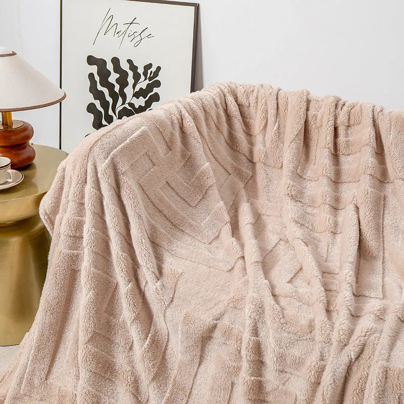 Thick coral fleece flannel sofa blanket in a solid colour, laid flat showing its texture.