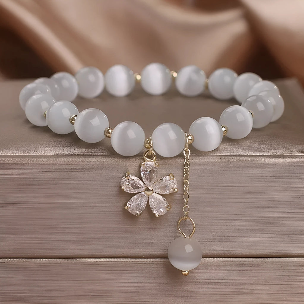 Women's white cat's eye stone bracelet with floral tassel and safety buckle clasp