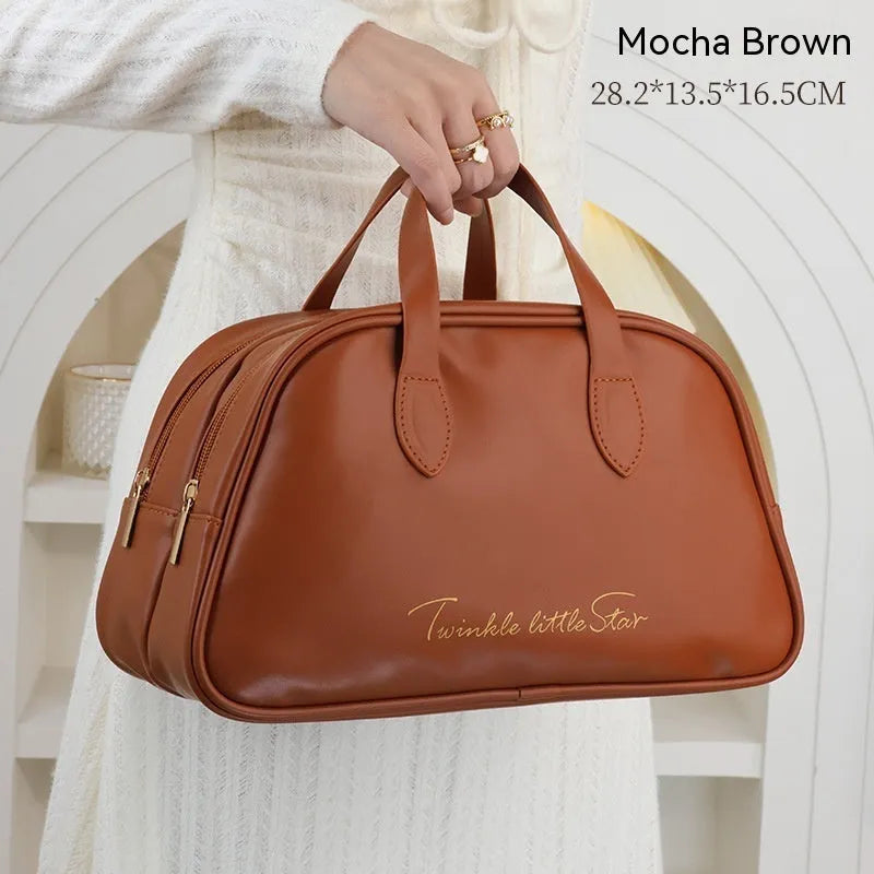 Leather travel toiletry bag open, showing interior compartments and dry-wet separation, in caramel mocha colour.
