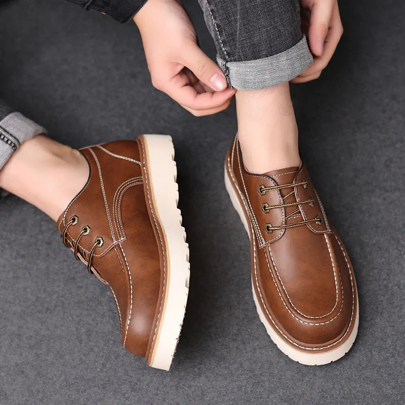 Men's black low top Martin boots with round toe and non-slip rubber sole on a neutral background.