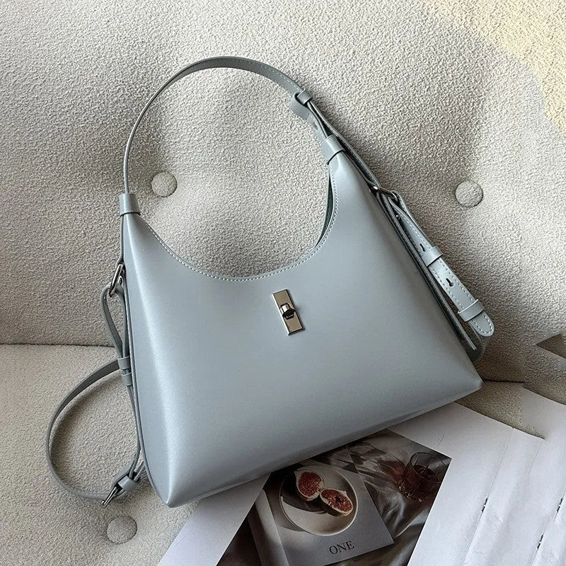 Soft genuine leather dumpling-shaped crossbody bag in apricot with sewing thread detail.