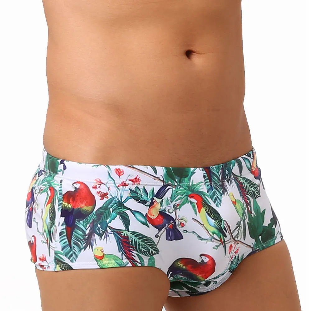 Men's floral bird print nylon swim trunks in boxer style on white background