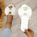Leopard print women's beach slippers with thick sole and round toe in black colour.