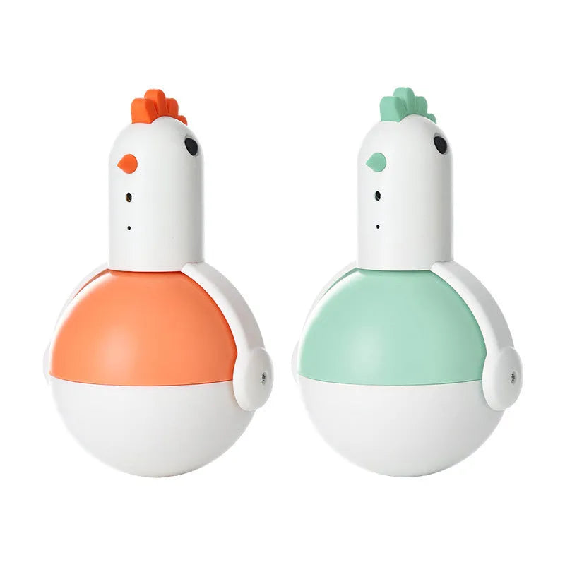 Green and orange electric cat toy chicken shape with laser light and motion features on a floor.