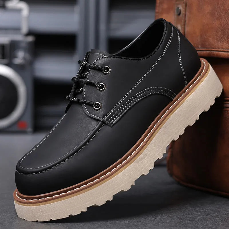 Men's black low top Martin boots with round toe and non-slip rubber sole on a neutral background.