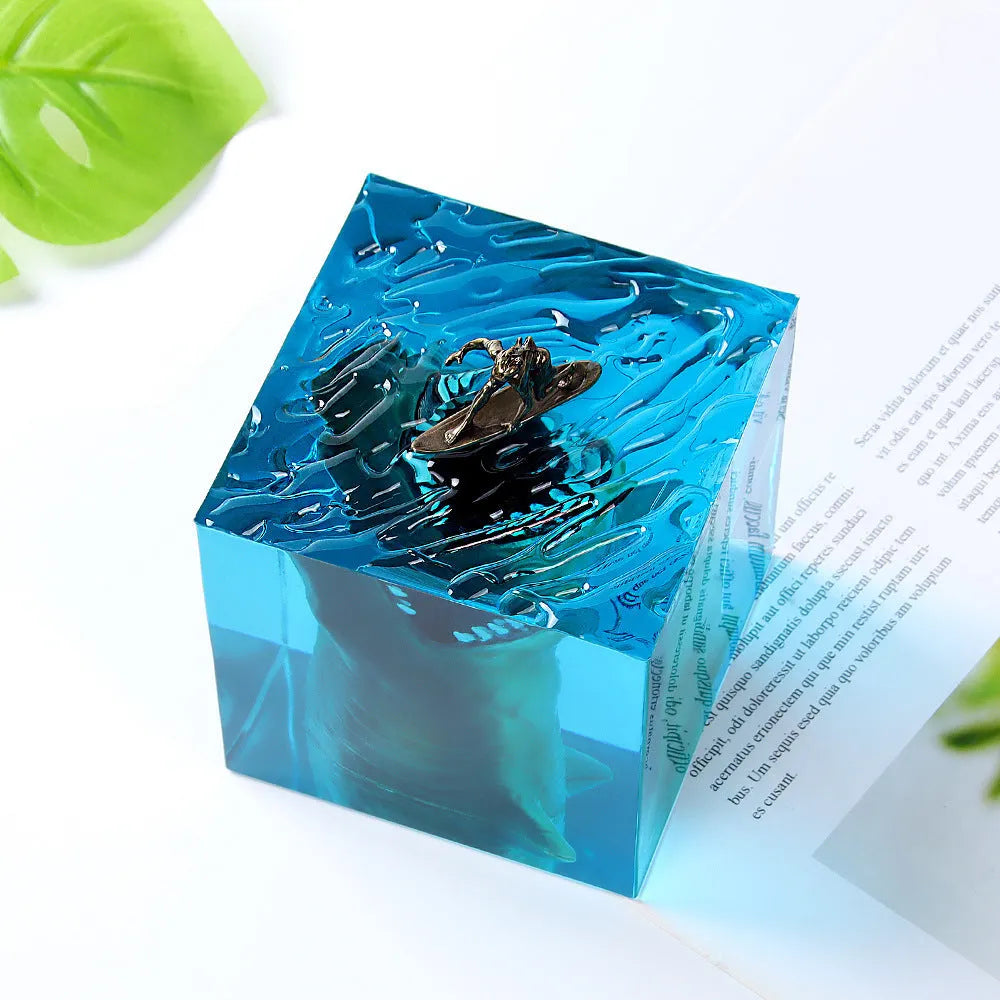 Clear epoxy resin night light ornament with a shark surfer scene inside, shown in 5cm and 8cm sizes.