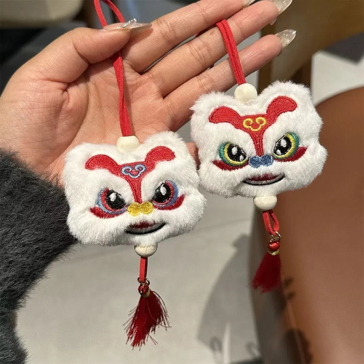 Blue and yellow handmade plush cartoon lion keychain with long tassel and star stone decoration.