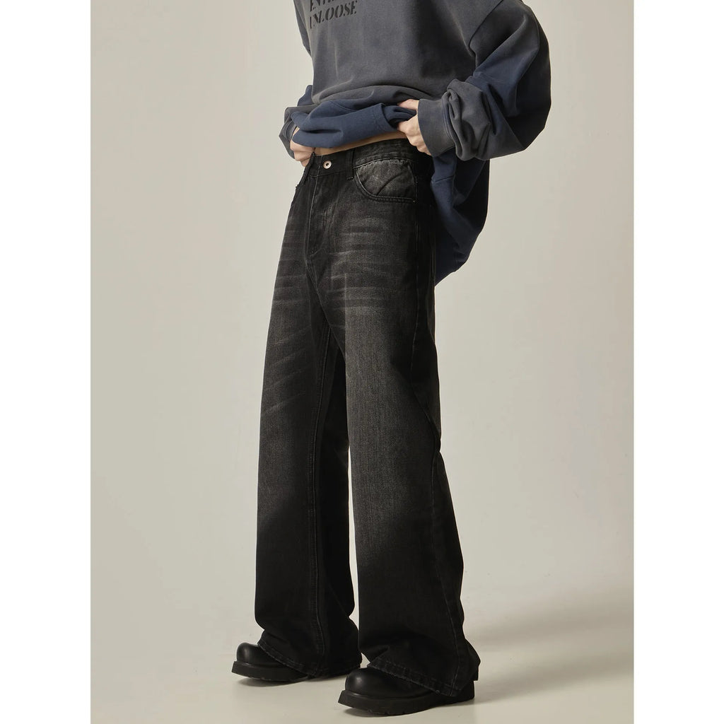 Black loose-fit straight-leg retro jeans with a zipper fly on a mannequin.