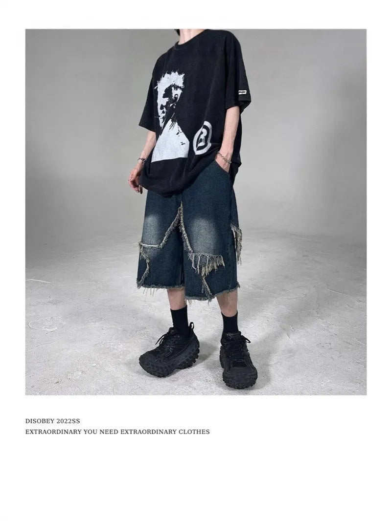 Men's blue retro denim shorts with a frayed five-pointed star design on the leg, showing loose fit.