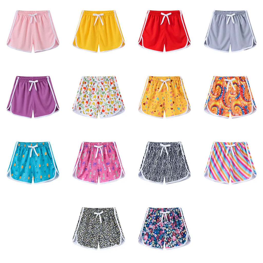 Children's casual polyester shorts in a selection of colours and patterns including stripes and fruit prints.