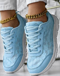 Women's white canvas sports shoes with flat heel and round toe on a plain background.