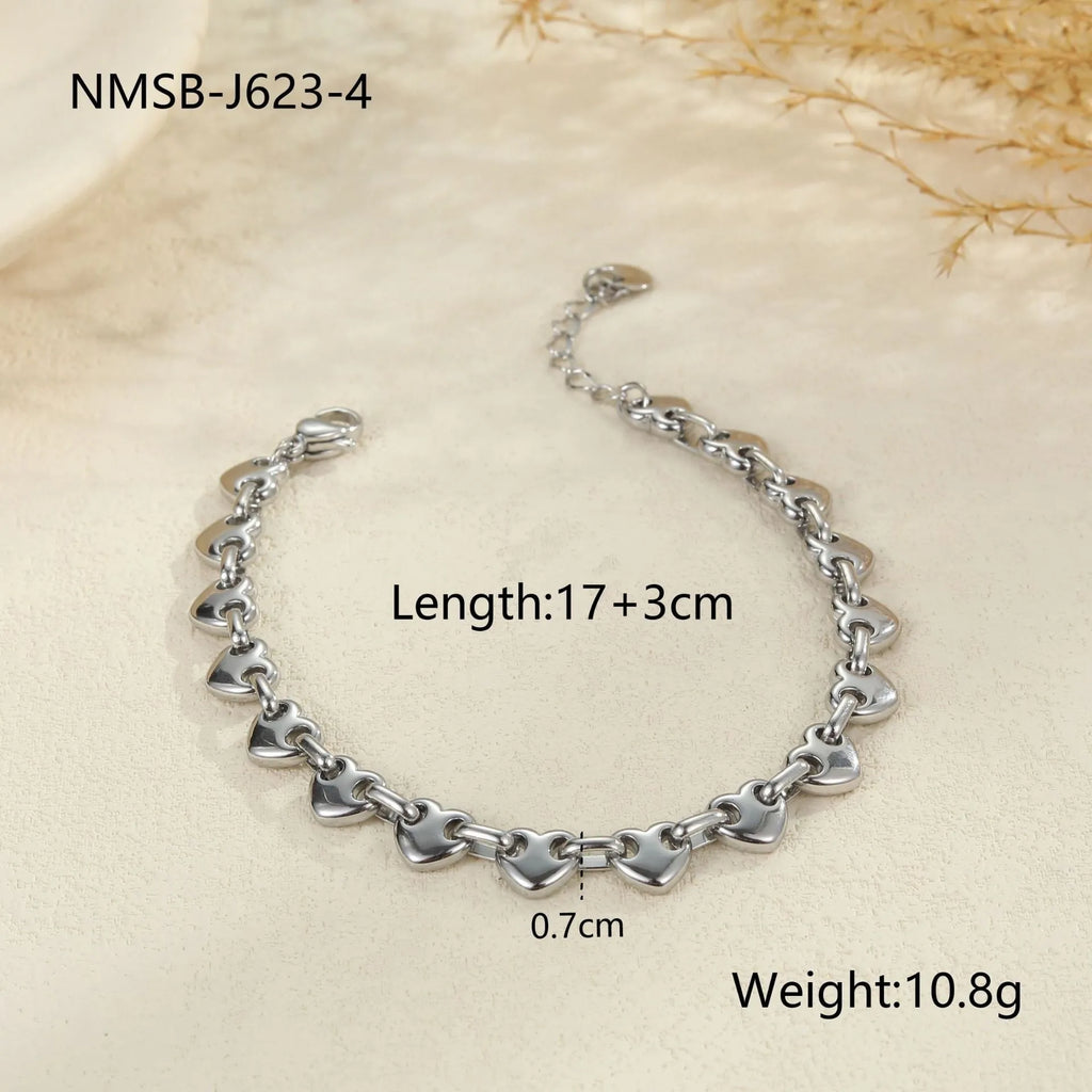 Women's hollowed-out heart bracelet in gold or steel colours with big heart and small heart size options