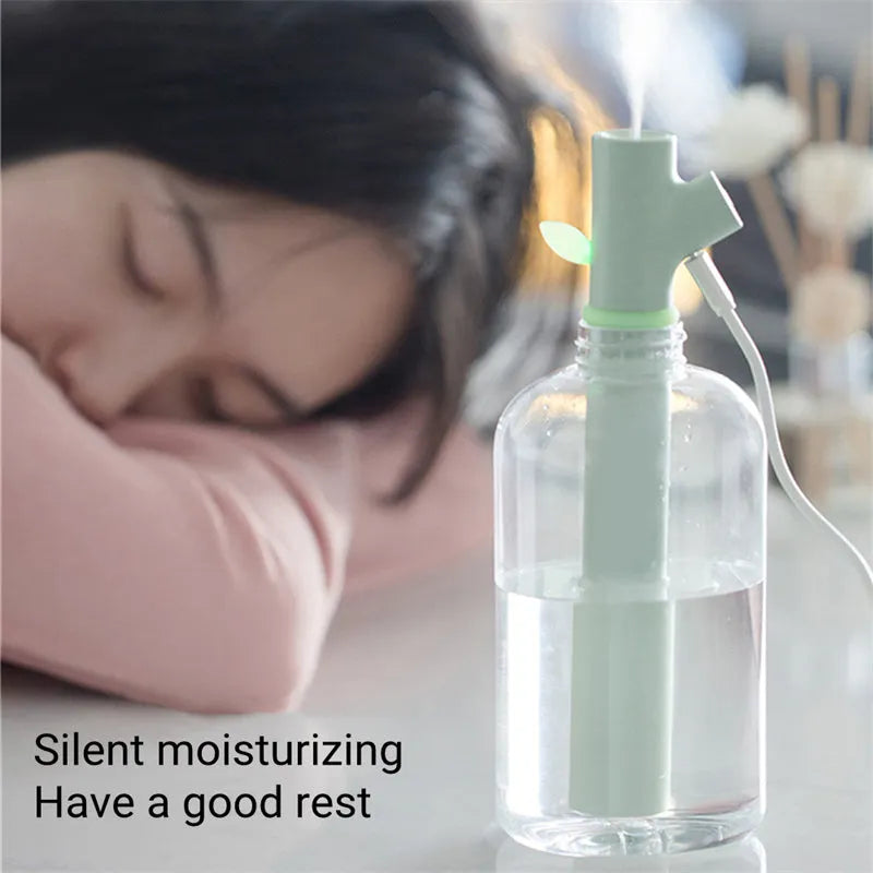 Transparent plastic portable USB humidifier on a desk with mist output