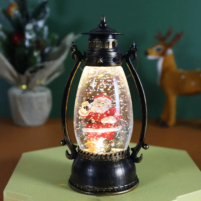 Clear plastic crystal ball oil lamp with LED light, showing snowman and elderly figure design options.