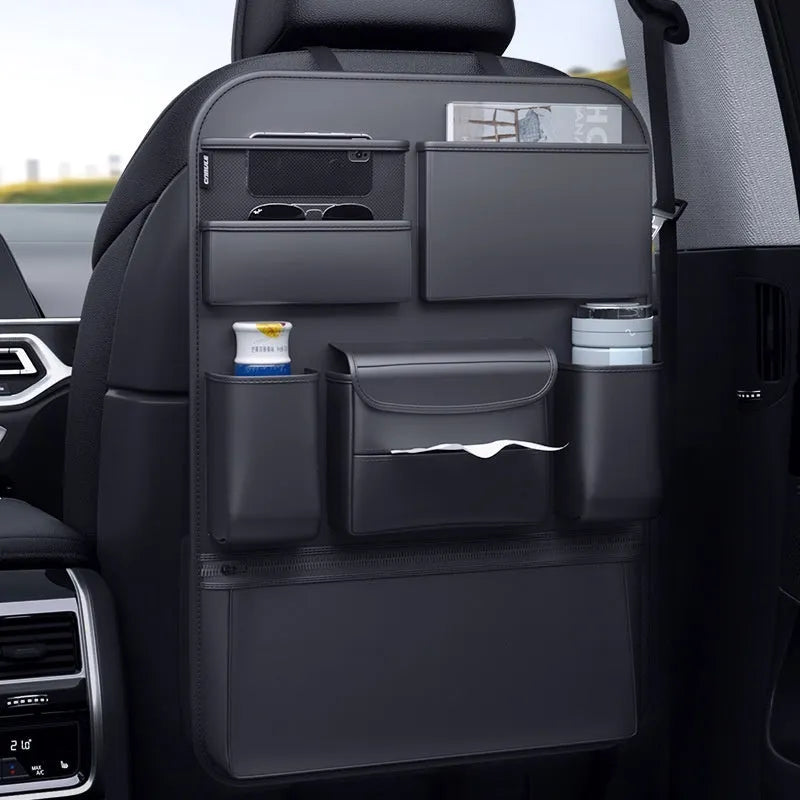 Black leather car seat back storage hanging bag with handle shown on vehicle headrest
