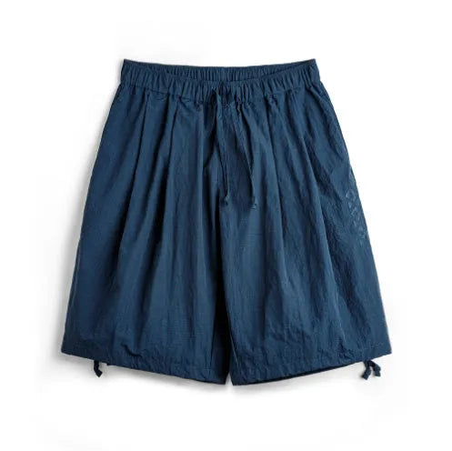 Men's loose Prussian Blue nylon beach shorts with embroidered detail and straight cut