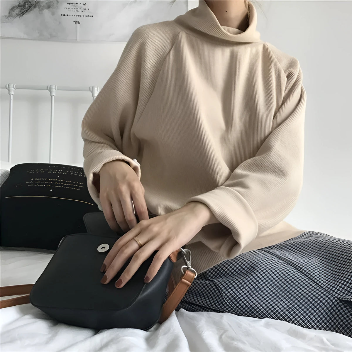 Women's loose fit half-high collar long sleeve top in solid colour on a hanger.