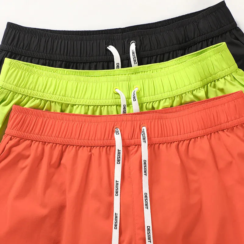 Men's loose orange red polyester beach trousers for surfing and swimming on a summer day.