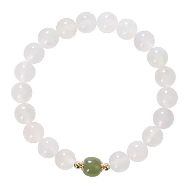 Handmade white agate and cinnabar crystal bracelet showing bead detail and inlay work