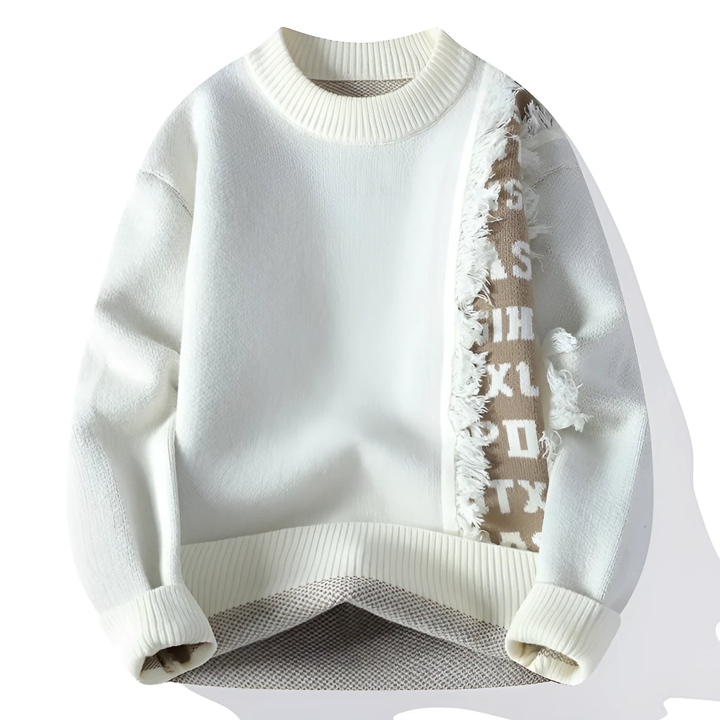 Man wearing a grey loose fit knitted pullover with a ribbed hemline.