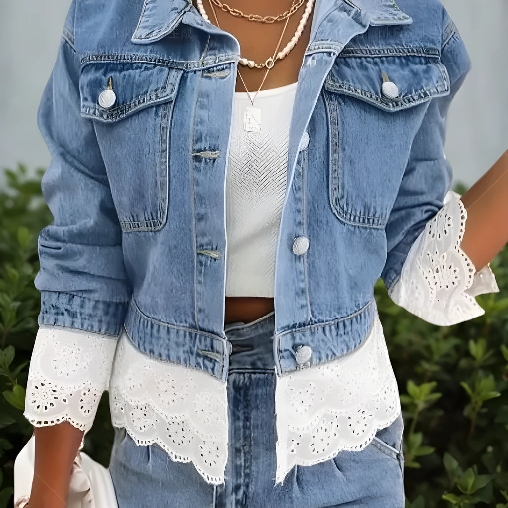 Blue women's denim jacket with decorative lace stitching detail on the front.