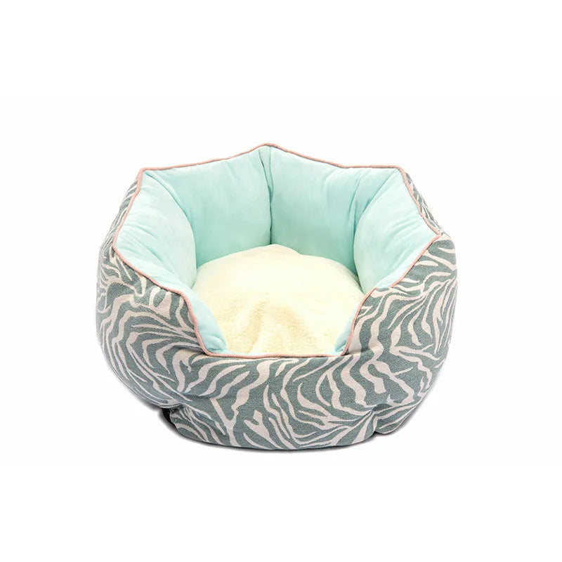 Octagonal grey pet bed with soft padded rim and removable inner mat for a small dog