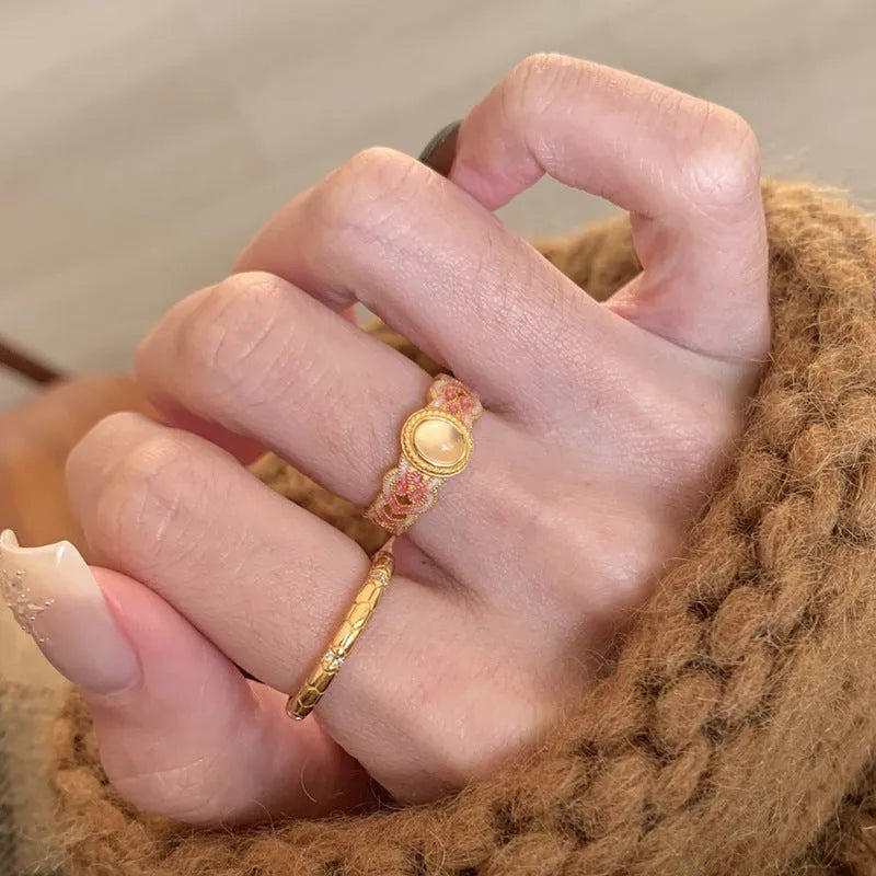 Open geometric ring with pink crystal enamel decoration and gold-plated finish, adjustable design