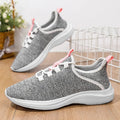 Women's low-top casual sneakers in black with breathable mesh upper and white EVA sole.
