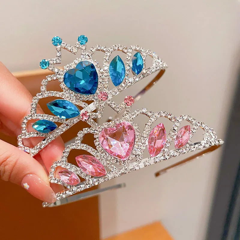 Children's metal headband with crystal crown design in pink, light blue, or light purple.