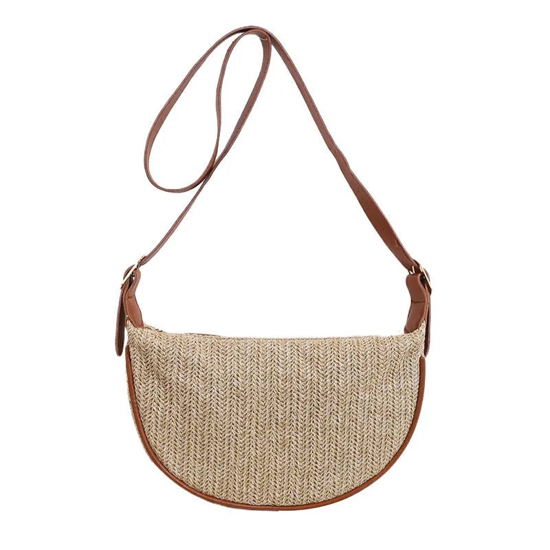 Women's knitted straw woven crossbody bag showing woven texture and internal phone/document compartments
