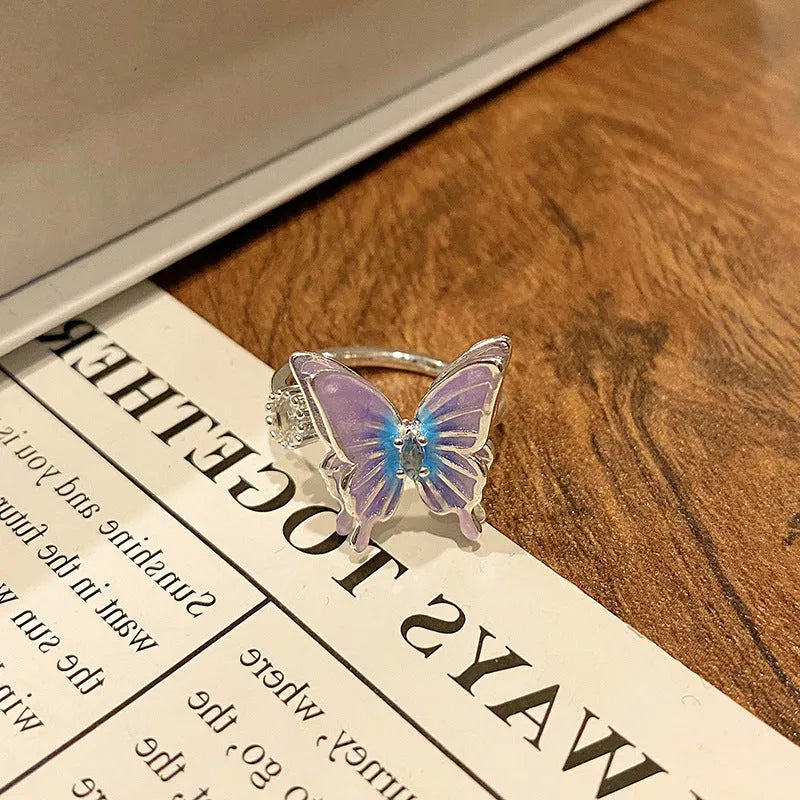Copper butterfly women's ring with drip oil finish in an open-loop design.