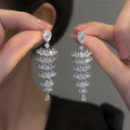 Silver Pagoda colour Christmas tree shaped drop earrings with stud fastenings and sparkling zircon finish.