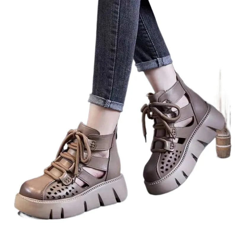 Women's black platform sandals with hollow hole design and fish mouth toe, made from soft leather.