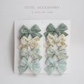 Set of children's cloth hair clips with a dovetail bow design in various colours.