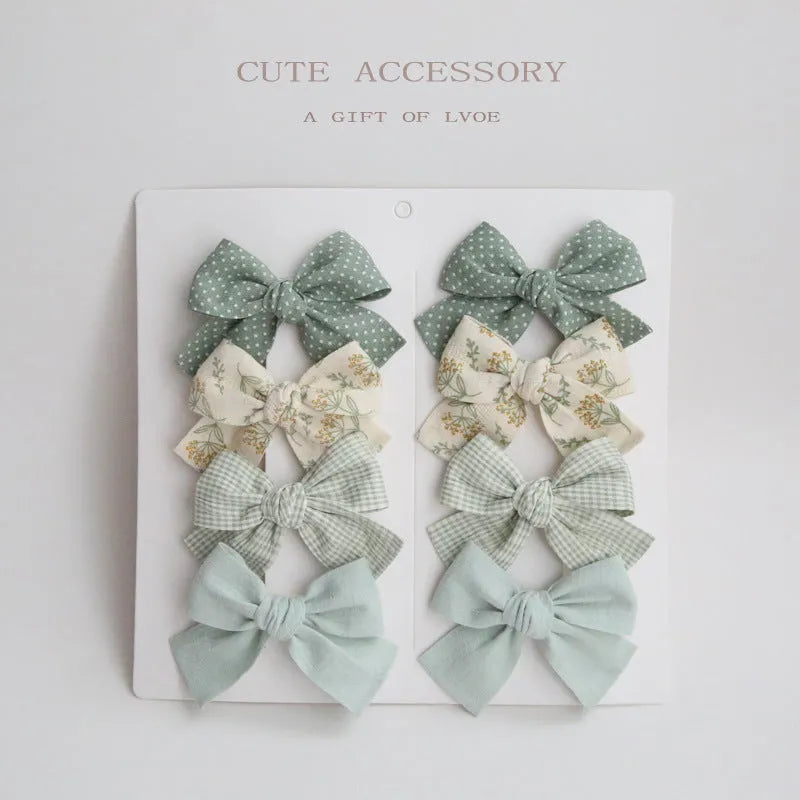 Set of children's cloth hair clips with a dovetail bow design in various colours.