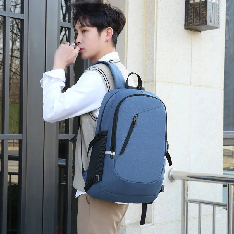Grey Oxford cloth computer backpack for men on a table, showing front view and size.