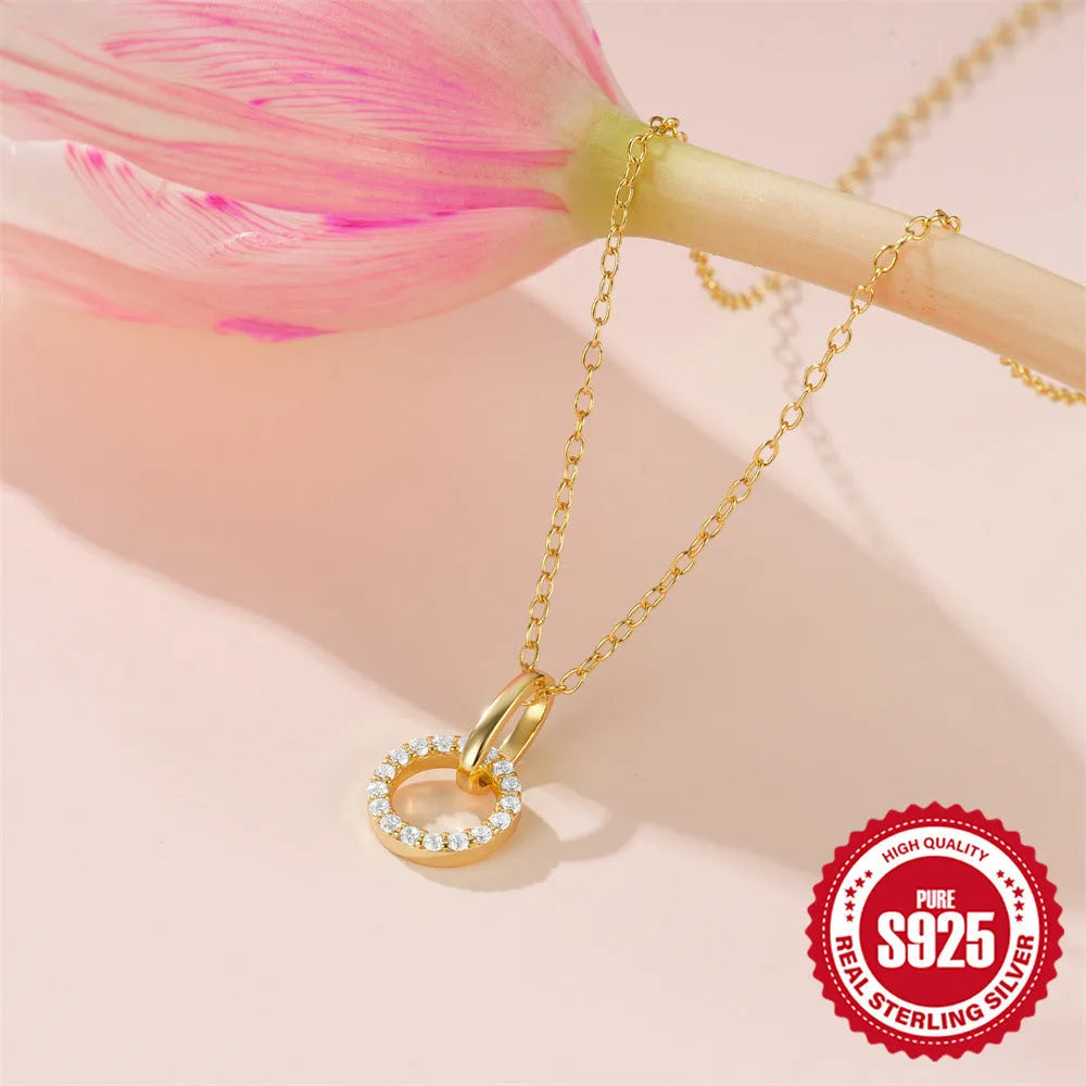 Gold-coloured sterling silver clavicle chain with interlocking geometric design and zircon stones