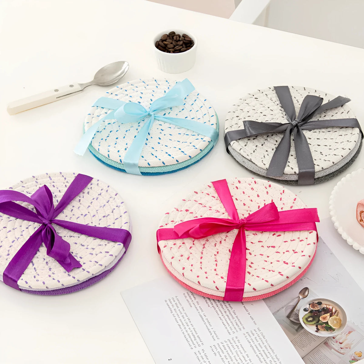 Three round cotton cord coasters in blue colour set on wooden table