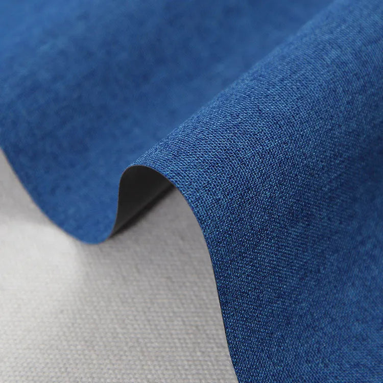 Black, blue, and green swatches of polyester Ant Cloth fabric on a roll.