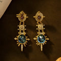 Geometric gold coloured retro stud earrings with round design elements on alloy stud backs